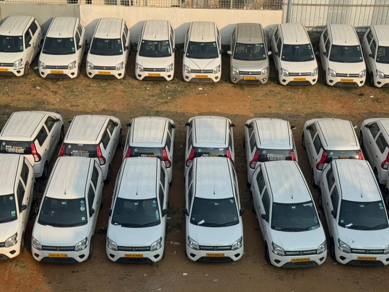 U Drive Fleet yard — rows of yellow-board commercial taxis lined up ready for dispatch